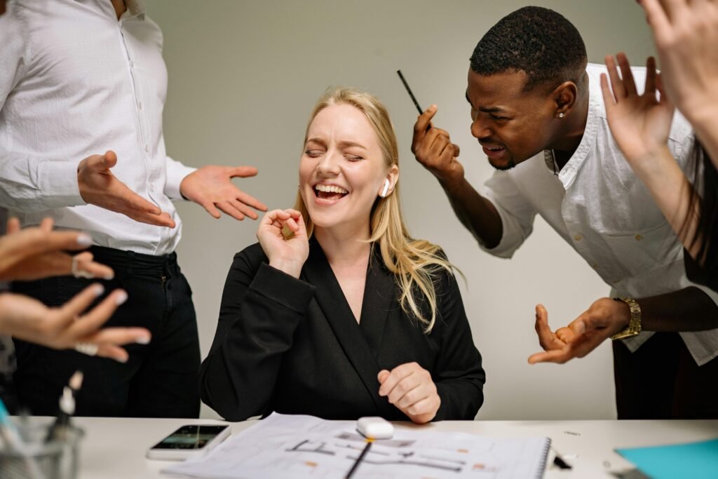Conceptual image of office conflict with a woman facing workplace pressure surrounded by colleagues.